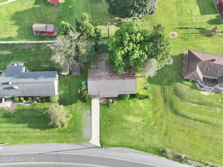 Overhead aerial view of the house, driveway to the road and surrounding lawn